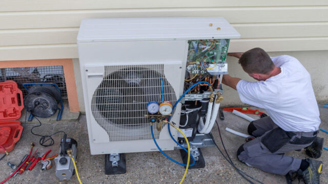 Heat Pump. plumber at work installing a circulation pump